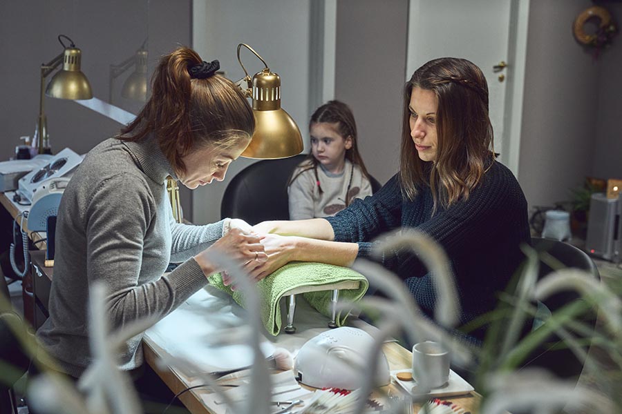 The Nail Industry in California: Challenges and New Sanitation Regulations 2 A woman and a girl doing manicure